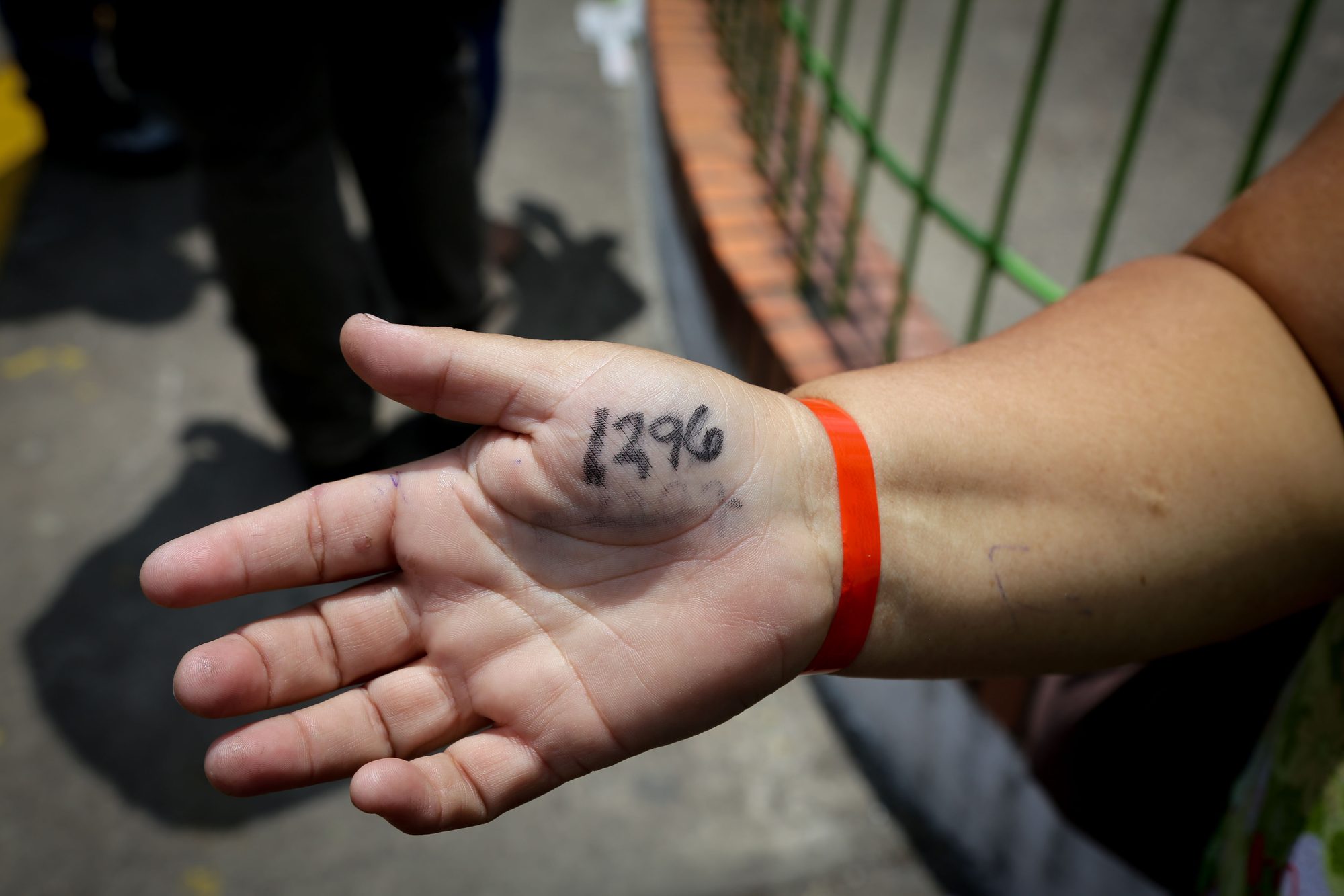 Woman is 1,296th in line to buy flour at a supermarket.