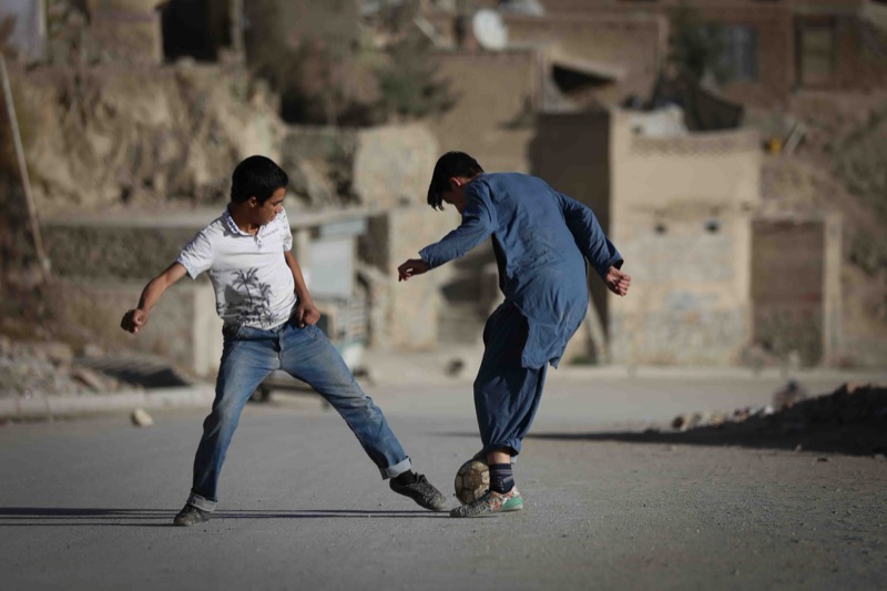 Boys play soccer.