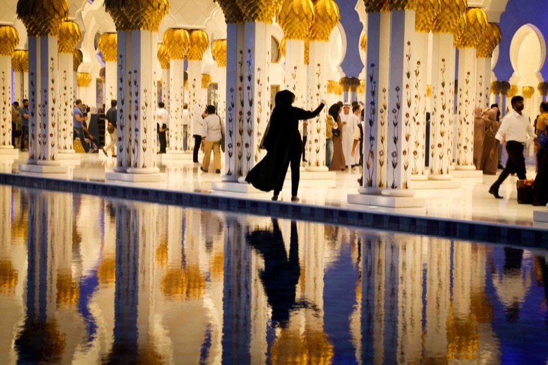Lady taking a self-portrait at the mosque.
